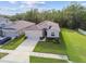 Aerial view of a single-story home with an attached two-car garage, set on a landscaped lot at 15354 Sweet Springs Bnd, Odessa, FL 33556
