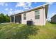 Home exterior featuring a screened-in patio and a well-maintained lawn at 15354 Sweet Springs Bnd, Odessa, FL 33556
