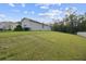 Spacious backyard with green grass and view of home at 15354 Sweet Springs Bnd, Odessa, FL 33556