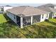 Screened in porch that overlooks the spacious and lush green lawn at 15354 Sweet Springs Bnd, Odessa, FL 33556