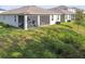 Green backyard featuring a screened in porch and lawn at 15354 Sweet Springs Bnd, Odessa, FL 33556