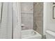 Bathroom boasts a shower and tub combination with tile surround and brushed fixtures at 15354 Sweet Springs Bnd, Odessa, FL 33556