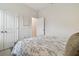 Comfortable bedroom features light neutral colors, a floral comforter, and two closets at 15354 Sweet Springs Bnd, Odessa, FL 33556