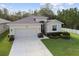 Charming single-story home with a well-manicured lawn and attached two car garage at 15354 Sweet Springs Bnd, Odessa, FL 33556
