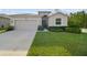 Attractive home showcasing a well-kept lawn, two-car garage, and welcoming front door at 15354 Sweet Springs Bnd, Odessa, FL 33556