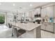Bright and airy kitchen featuring stainless steel appliances, granite countertops, and a spacious island with seating at 15354 Sweet Springs Bnd, Odessa, FL 33556