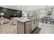Open-concept kitchen and living area featuring modern finishes, granite countertops, and stylish decor at 15354 Sweet Springs Bnd, Odessa, FL 33556