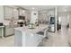 Modern kitchen featuring granite countertops, stainless steel appliances, and a spacious island with seating at 15354 Sweet Springs Bnd, Odessa, FL 33556