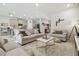 Bright living room boasts neutral decor, plush sofas, and an open layout adjacent to the kitchen at 15354 Sweet Springs Bnd, Odessa, FL 33556