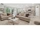 Open-concept living room with a view of the kitchen, dining, and patio at 15354 Sweet Springs Bnd, Odessa, FL 33556