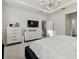 Bright bedroom with modern dressers, a tv, and a comfortable bed at 15354 Sweet Springs Bnd, Odessa, FL 33556