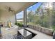 Relaxing screened patio offers wooded views and features comfortable seating arrangements at 15354 Sweet Springs Bnd, Odessa, FL 33556