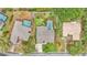 Aerial view of a well-maintained property featuring a pool, mature trees, manicured lawn, and neat landscaping at 2912 Aston Ave, Plant City, FL 33566