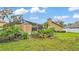 View of spacious backyard featuring screened-in patio and landscaping at 2912 Aston Ave, Plant City, FL 33566