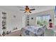 Bright bedroom with a ceiling fan, charming decor, and ample natural light at 2912 Aston Ave, Plant City, FL 33566