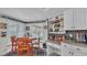 Charming dining area featuring a round table, wood chairs, and windows with shutter blinds, creating a cozy space at 2912 Aston Ave, Plant City, FL 33566
