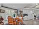 Inviting dining area with a wooden table, shuttered windows, and built-in shelves, perfect for Gathering meals at 2912 Aston Ave, Plant City, FL 33566