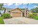 Attractive home exterior with a two car garage, well-maintained lawn, and landscaped beds at 2912 Aston Ave, Plant City, FL 33566