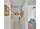 Inviting hallway adorned with beautiful art leading to the bedrooms at 2912 Aston Ave, Plant City, FL 33566