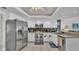 Well-lit kitchen with white cabinetry, stainless steel appliances, and granite countertops, offering ample cooking space at 2912 Aston Ave, Plant City, FL 33566
