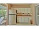 Convenient outdoor kitchenette featuring white cabinets, sink, and stainless steel refrigerator at 2912 Aston Ave, Plant City, FL 33566