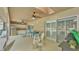 Spacious covered lanai featuring ceiling fans, outdoor kitchen, and comfortable seating at 2912 Aston Ave, Plant City, FL 33566
