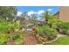 Tropical landscaping with a partially obscured view of the screened in pool at 2912 Aston Ave, Plant City, FL 33566