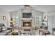 Inviting living room featuring a fireplace, large windows, and comfortable seating, perfect for entertaining guests at 2912 Aston Ave, Plant City, FL 33566