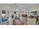 Bright living room with vaulted ceiling, wood flooring, and an open layout to the dining area and office at 2912 Aston Ave, Plant City, FL 33566