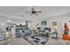 Bright living area with two sofas, a ceiling fan, and an adjacent kitchen, all enhanced by natural light at 2912 Aston Ave, Plant City, FL 33566