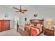 Comfortable main bedroom boasts ceiling fan, neutral carpet, and a walk-in doorway to the bathroom at 2912 Aston Ave, Plant City, FL 33566