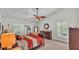 Main bedroom features neutral carpet, ceiling fan, and large windows with shutters for natural light at 2912 Aston Ave, Plant City, FL 33566