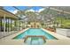 Inviting screened-in pool and spa surrounded by lush landscaping and tranquil water feature at 2912 Aston Ave, Plant City, FL 33566