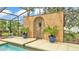 Unique water feature on pool deck, accented with potted plants and a serene ambiance at 2912 Aston Ave, Plant City, FL 33566