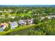 Stunning aerial view of the community with lush greenery, golf course, and serene pond at 3620 Cordgrass Dr, Valrico, FL 33596
