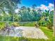 Charming backyard stone patio with seating and lush greenery, perfect for relaxation and enjoying nature at 3620 Cordgrass Dr, Valrico, FL 33596
