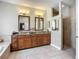 Elegant bathroom with dual sinks, granite countertops, and a walk-in shower at 3620 Cordgrass Dr, Valrico, FL 33596