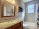 Well lit bathroom featuring a vanity, toilet, shower and tub at 3620 Cordgrass Dr, Valrico, FL 33596