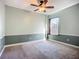 Bedroom featuring a ceiling fan, closet, carpet, and a double-hung window for natural light at 3620 Cordgrass Dr, Valrico, FL 33596
