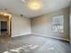 Bedroom featuring a window for natural light, neutral carpet, and access to a hallway at 3620 Cordgrass Dr, Valrico, FL 33596
