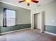This bedroom boasts a ceiling fan, closet, carpet, and a double-hung window for natural light at 3620 Cordgrass Dr, Valrico, FL 33596