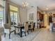 Bright dining room with a chandelier, large window, and neutral color scheme at 3620 Cordgrass Dr, Valrico, FL 33596