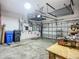 Clean and spacious garage with overhead storage and an electric garage door at 3620 Cordgrass Dr, Valrico, FL 33596