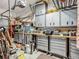 Organized garage featuring lots of shelving, cabinets, and a workbench at 3620 Cordgrass Dr, Valrico, FL 33596