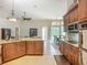 Bright kitchen with granite countertops, stainless steel appliances, and an adjacent dining area at 3620 Cordgrass Dr, Valrico, FL 33596