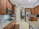 Gourmet kitchen featuring granite countertops, stainless appliances, and wood cabinetry at 3620 Cordgrass Dr, Valrico, FL 33596