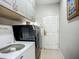 Efficient laundry room with ample cabinet storage and modern washer and dryer at 3620 Cordgrass Dr, Valrico, FL 33596