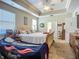 Bright main bedroom featuring carpet, neutral colors, a tray ceiling, and large windows at 3620 Cordgrass Dr, Valrico, FL 33596