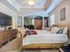 Spacious main bedroom with tray ceilings, carpet flooring, and a view of the room at 3620 Cordgrass Dr, Valrico, FL 33596
