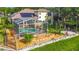 Private backyard with solar panels, a screened pool, lush landscaping, and a stone patio at 3620 Cordgrass Dr, Valrico, FL 33596